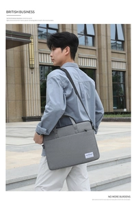 Detail view of dark grey canvas business laptop bag with top handle and shoulder strap
