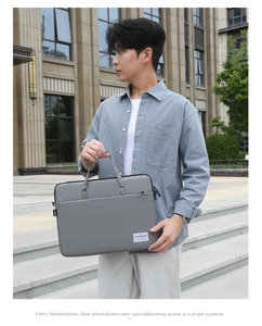 Close-up of durable gray canvas laptop bag with tight anti-scratch texture and fashion label