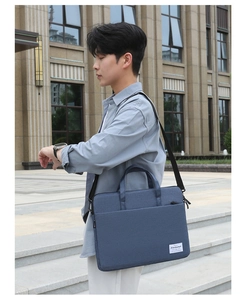 Detail of navy blue canvas business laptop bag with reinforced handles and shoulder strap