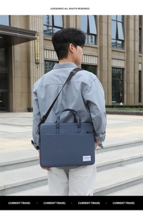 Detail of dark blue canvas laptop bag with adjustable shoulder strap on male model