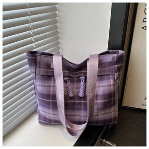 Detailed close-up of a purple checkered tote bag featuring woven rope knot zipper pulls