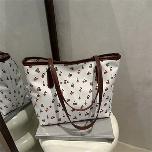 Fashionable cherry print tote bag with brown leather handles for women's daily commute
