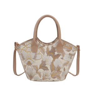 Elegant beige bucket bag with floral embroidery and brown leather top handles