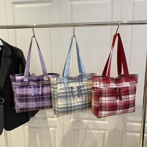 Three checkered plaid tote bags in purple, blue, and red with wide shoulder straps