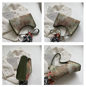 Detail view of vintage floral tapestry shoulder bag with olive green leather accents