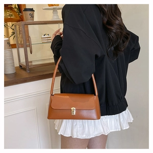 Brown faux leather underarm bag featuring a vintage golden rectangular metal lock detail