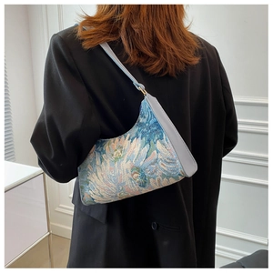 Detail of artistic oil painting pattern jacquard underarm bag with blue leather strap