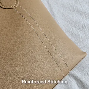 Close-up of reinforced double stitching on beige PU leather tote bag details