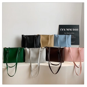 Modern minimalist tote bags displayed in seven various colors on a white tiered platform