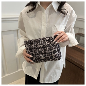 Detail of the quilted leopard print clutch bag showing soft fabric and texture