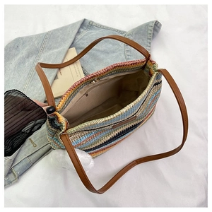 Macro view showing the striped woven bag interior with zipper pocket and lining