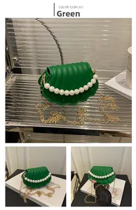 Detailed macro view of the green shell-shaped bag with pearl handle and golden chain