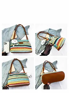 Detail view of colorful woven tote bag with brown leather straps and cloud charm accessory