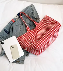 Detailed comparison of red plaid canvas tote bag capacity with tablet and phone