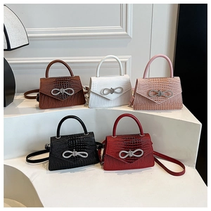 Five crocodile pattern mini tote bags with rhinestone bow buckles in various colors