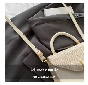 Detail of adjustable shoulder strap and gold hardware on beige woven crossbody handbag