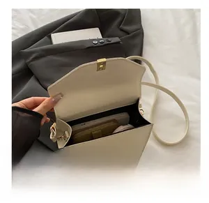 Internal capacity of the cream white crossbody square bag showing daily essentials