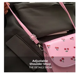 Detail of adjustable pink shoulder strap with silver buckle and cherry print PU leather