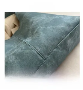Close-up of blue vintage texture tote bag with premium stitching and washed denim finish