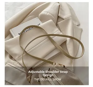 Detail of adjustable leather shoulder strap and drawstring closure on beige bucket bag