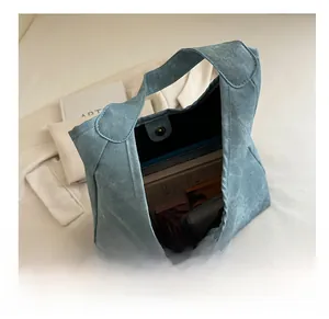 Detail view of spacious canvas tote bag interior with magnetic snap and textured fabric
