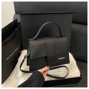 Détail du sac à main noir en similicuir avec logo JINGPIN doré dans un coffret
