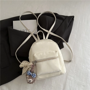 Mini ivory PU leather backpack with a cute brown plush charm and minimalist design