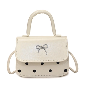 Schicke beige Handtasche mit schwarzen Punkten und silberner Schleife für Damen
