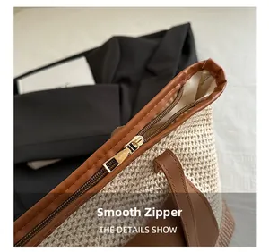 Close-up of smooth gold metal zipper and leather trim on woven straw shoulder bag