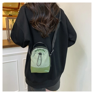 Mini grüne Umhängetasche mit Kordelzug aus Nylon und verstellbarem Schultergurt-Detail