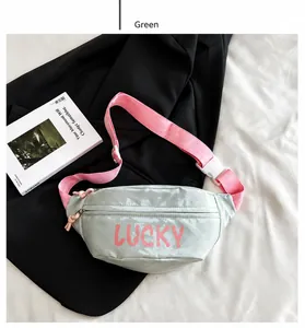 Detail of green nylon waist bag with pink LUCKY lettering and adjustable strap