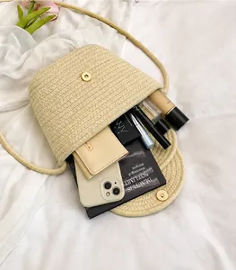 Detailed interior of woven bucket bag showing capacity for phone and cosmetics