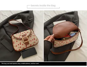 Detail view of the interior space of the vintage cherry print saddle bag and its main pocket