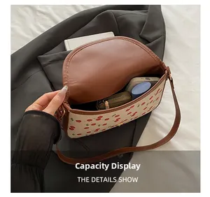 Internal view of cherry print canvas crossbody bag showing phone and wallet storage