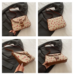 Four views of a cream canvas cherry print shoulder bag with brown leather accents