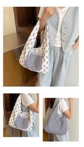 Detail view of reversible floral tote bag with blue bows and black gingham patterns