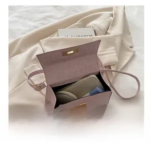Open view of pink textured flap bag showing storage for phone, lipstick and makeup
