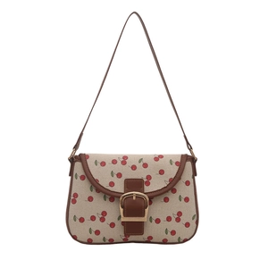 Minimalist beige canvas underarm bag with cherry print and golden buckle detail