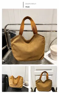 Detail shot of the khaki canvas tote bag showing thick fabric and reinforced wide handles