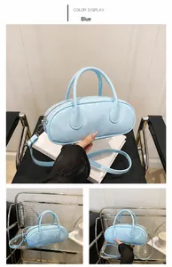 Detail of blue faux leather Boston bag with double handles and adjustable strap