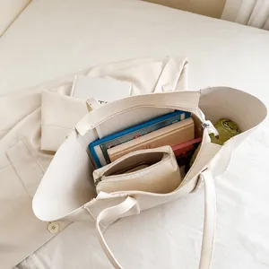 Macro view of large beige tote bag interior showing ample storage for a tablet and umbrella