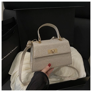 Detail of champagne gold sequined handbag in a premium gift box with satin lining