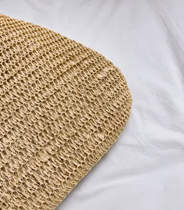 Detailed macro view of the natural straw woven texture and durable pattern of this tote bag
