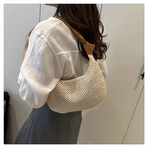 Detail der beige gewebten Hobo-Tasche mit braunem geknotetem Leder-Schultergurt