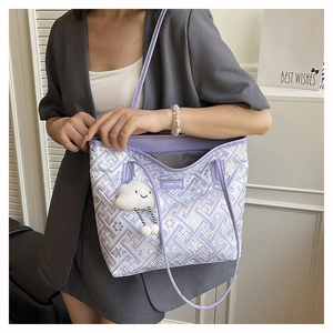 Detail of lavender tote bag with jacquard floral pattern and plush cloud charm