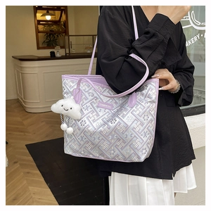 Detail of purple geometric tote bag with Creative Girl label and plush cloud charm