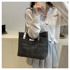 Mirror selfie showing the large capacity grey denim tote bag with silver metallic handles