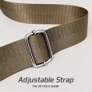 Detail of adjustable khaki nylon shoulder strap with silver metal buckle on crossbody bag