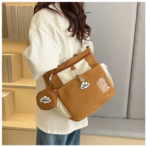 Detail of color-block canvas bucket bag with mini round coin purse and transparent slot