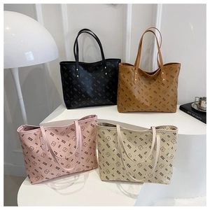 Detail of four colorful tote bags with bear print arranged on a minimalist white table